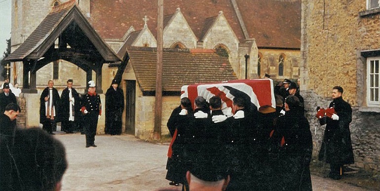 On the day of the funeral, the coffin, carried by members of the Queen’s Royal Irish Hussars, approaches  the lychgate, where the public aspect of the funeral came to an end and gave way to the private family interment.